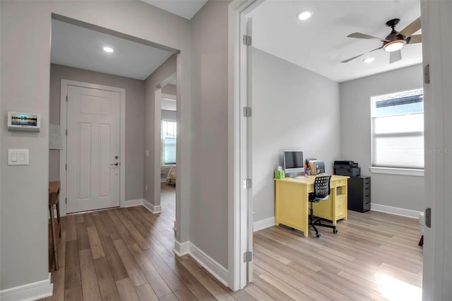 office area featuring ceiling fan, a healthy amount of sunlight, and light hardwood / wood-style floors