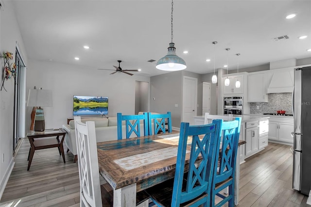 dining area featuring ceiling fan and light wood-type flooring