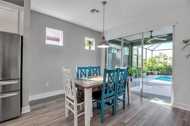 dining room with hardwood / wood-style floors and ceiling fan