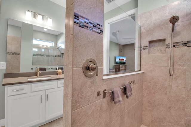 bathroom with vanity and tiled shower