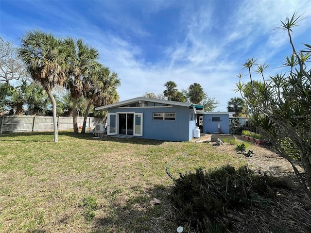 rear view of house featuring a yard