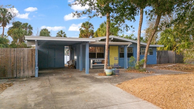 3863 Belle Vista Dr E, St Pete Beach, FL 33706 - view of front of home with driveway and a carport