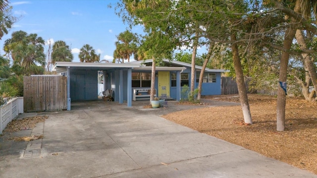 view of front of house with covered porch and a carport