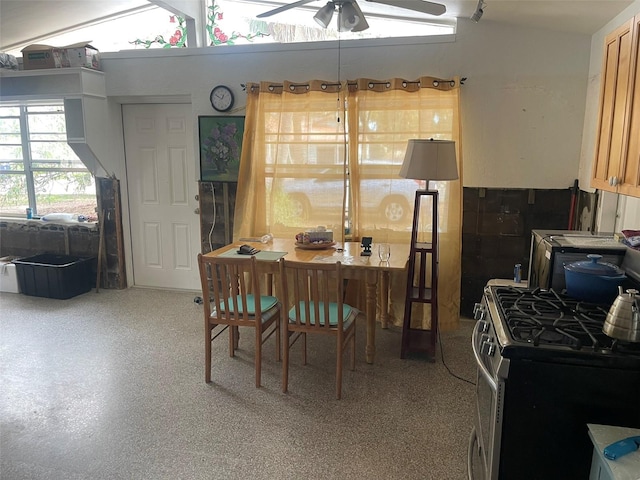 dining area with ceiling fan and vaulted ceiling