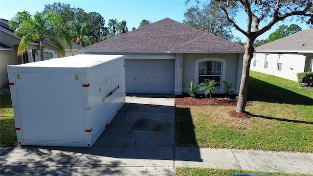 view of front of house with a front yard and a garage