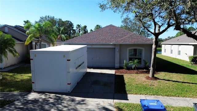 ranch-style home featuring a garage and a front lawn