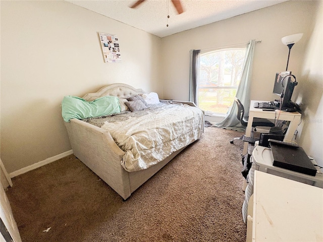 carpeted bedroom featuring ceiling fan and a textured ceiling