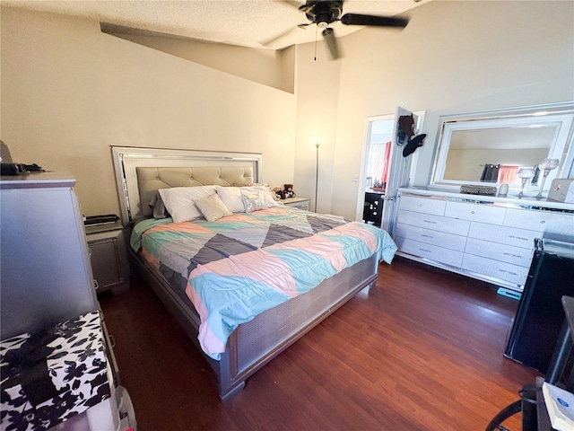 bedroom with a textured ceiling, dark hardwood / wood-style flooring, ceiling fan, and lofted ceiling