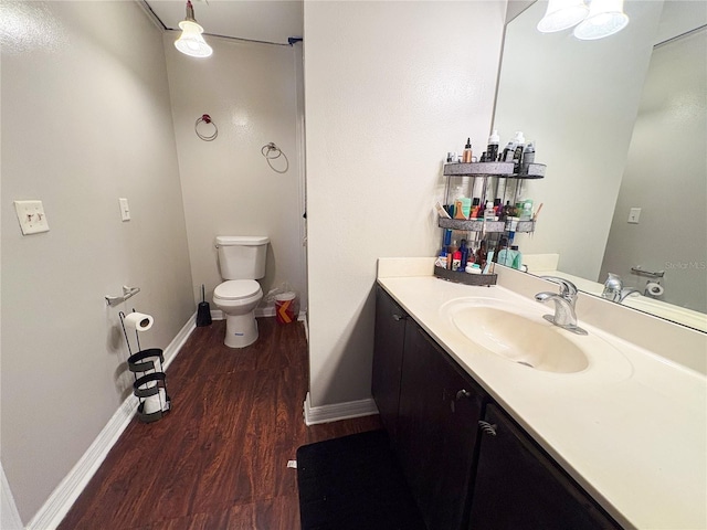 bathroom with vanity, toilet, and wood-type flooring