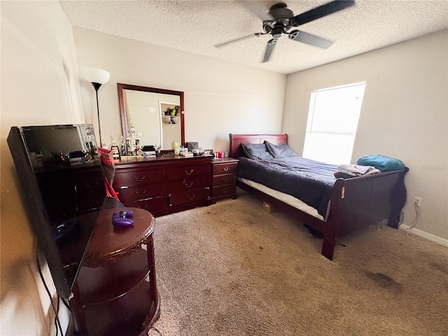 bedroom featuring ceiling fan, carpet floors, and a textured ceiling