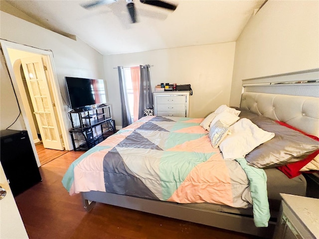 bedroom featuring hardwood / wood-style floors, ceiling fan, and lofted ceiling