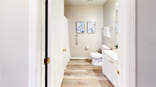 10543 Opus Dr, Riverview, FL 33579 - bathroom featuring wood finished floors, vanity, toilet, baseboards, and curtained shower