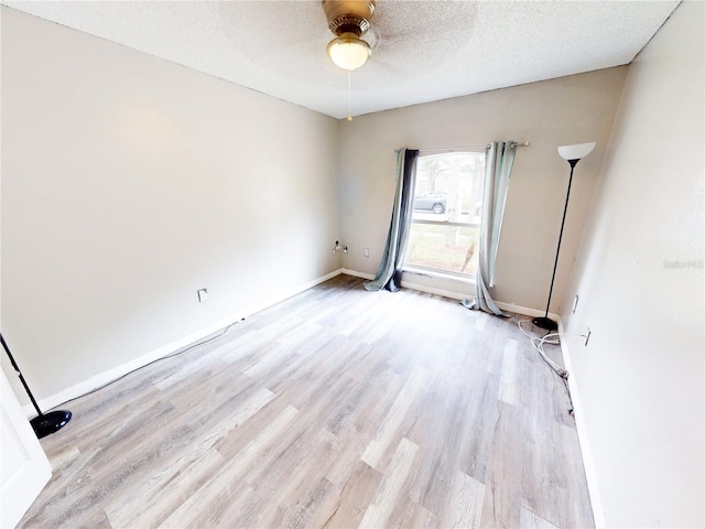 10543 Opus Dr, Riverview, FL 33579 - spare room featuring light wood-type flooring, a ceiling fan, a textured ceiling, and baseboards