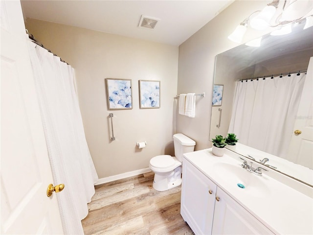 10543 Opus Dr, Riverview, FL 33579 - full bath with wood finished floors, toilet, vanity, and baseboards
