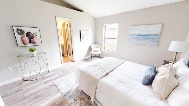 10543 Opus Dr, Riverview, FL 33579 - bedroom featuring lofted ceiling, wood finished floors, baseboards, and ensuite bathroom