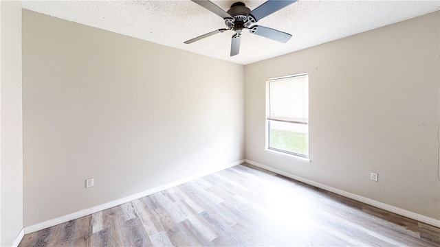 10543 Opus Dr, Riverview, FL 33579 - spare room featuring wood finished floors, baseboards, ceiling fan, and a textured ceiling