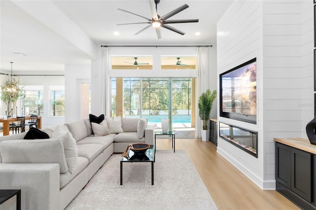 living room featuring a chandelier and light hardwood / wood-style flooring