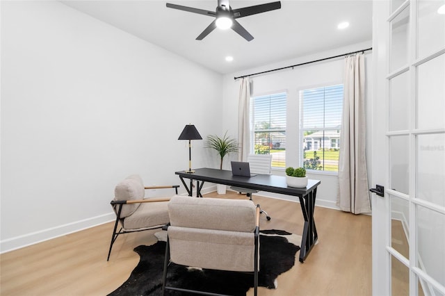 office area with light hardwood / wood-style flooring and ceiling fan