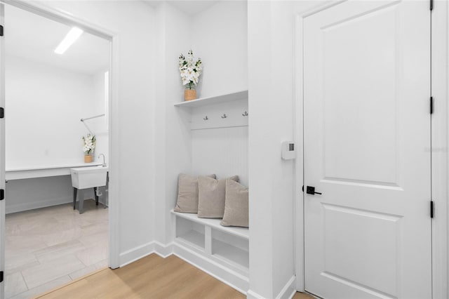 mudroom featuring wood-type flooring and built in desk