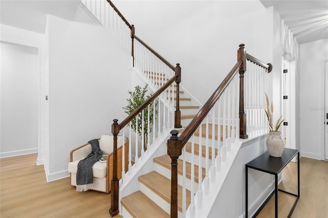 stairway featuring wood-type flooring