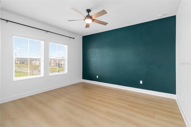 empty room with ceiling fan and light wood-type flooring