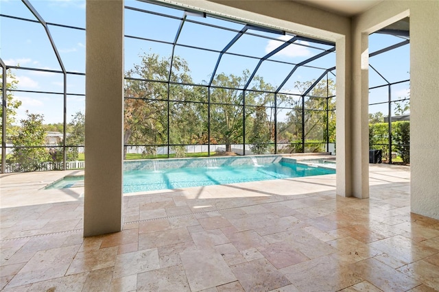 view of swimming pool with a patio, pool water feature, and glass enclosure