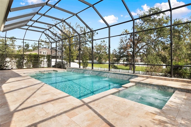 view of pool with an in ground hot tub, pool water feature, a patio area, and a lanai