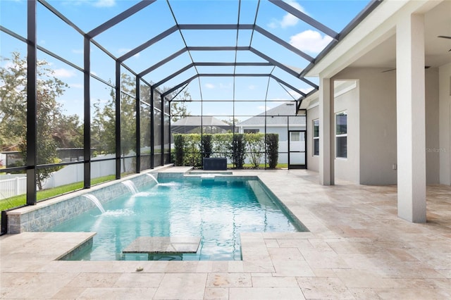 view of swimming pool with pool water feature, a patio area, and a lanai