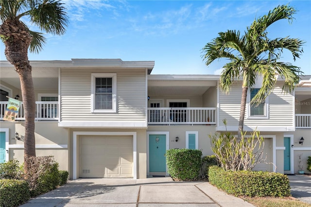 multi unit property featuring a balcony and a garage