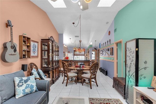 tiled dining area with lofted ceiling with skylight and a notable chandelier