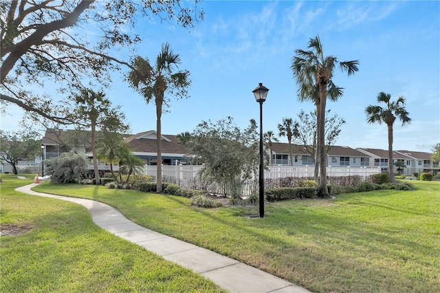 view of property's community featuring a yard