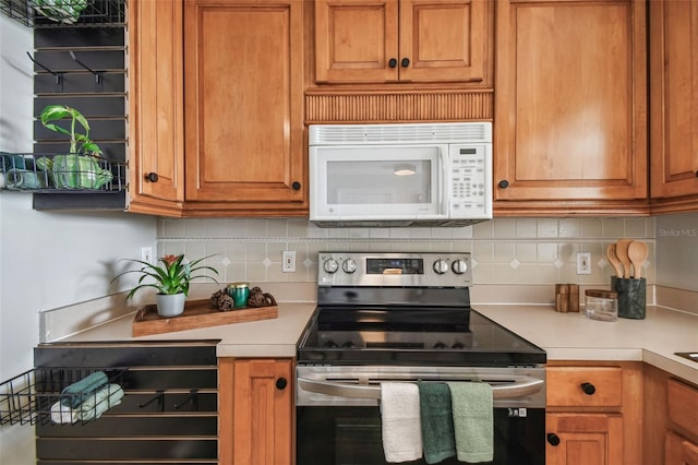 kitchen featuring tasteful backsplash and stainless steel electric stove