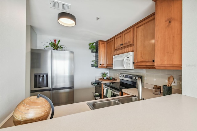 kitchen with decorative backsplash and stainless steel appliances