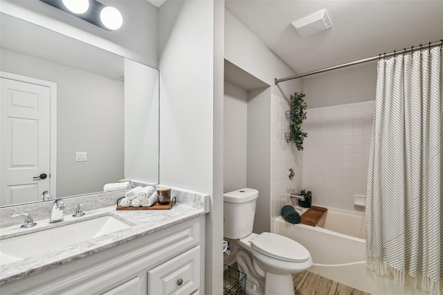 full bathroom featuring vanity, shower / bath combo, and toilet