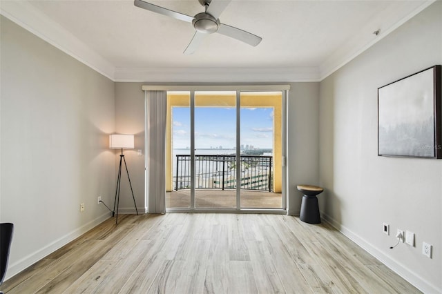 unfurnished room featuring light hardwood / wood-style flooring, ceiling fan, and ornamental molding