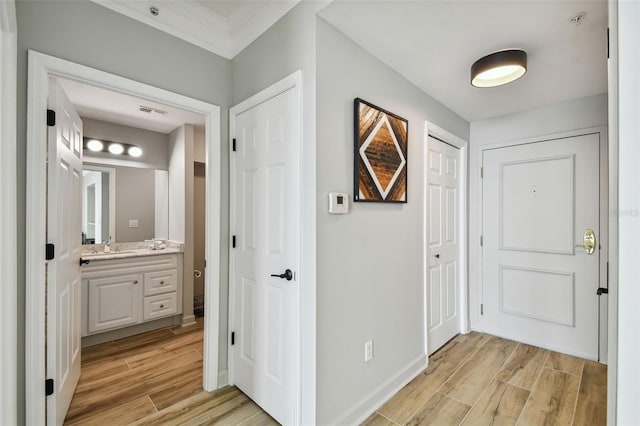 corridor featuring light hardwood / wood-style floors and sink