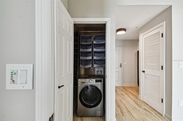 laundry area featuring washer / dryer and light wood-type flooring