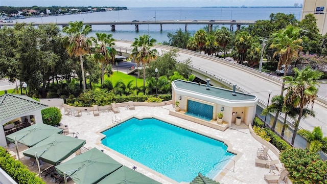 view of pool with a gazebo, a water view, and a patio area