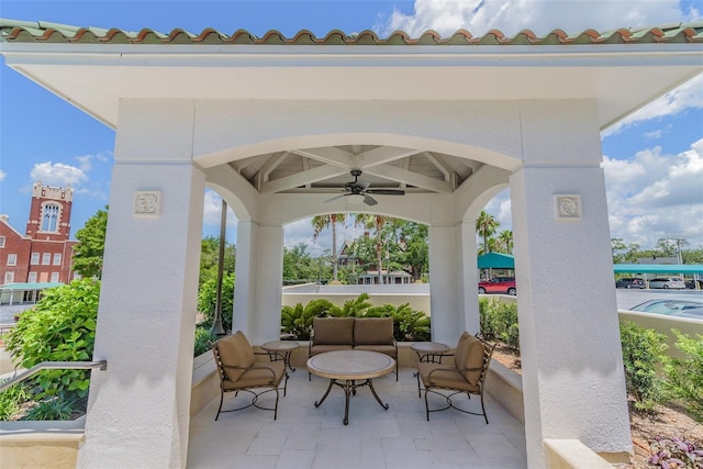 view of patio / terrace with ceiling fan and an outdoor living space