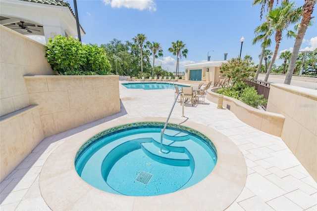 view of swimming pool with an in ground hot tub and a patio