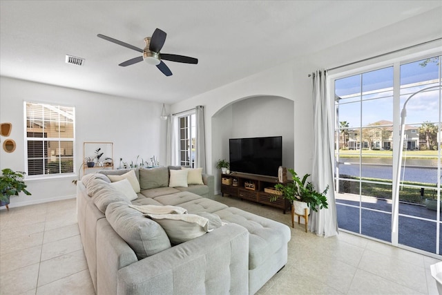 tiled living room featuring ceiling fan