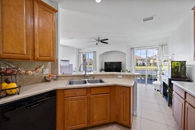 kitchen featuring kitchen peninsula, sink, plenty of natural light, and black dishwasher