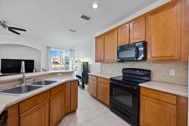 kitchen featuring decorative backsplash, sink, ceiling fan, and black appliances