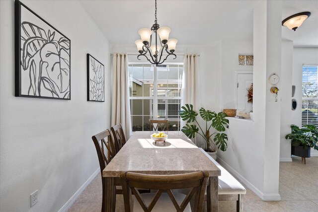 dining room with a notable chandelier and light tile patterned floors