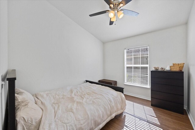 bedroom featuring hardwood / wood-style floors, ceiling fan, and lofted ceiling