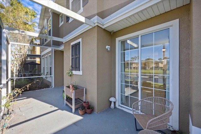 entrance to property featuring a patio