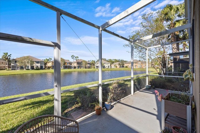 exterior space featuring a lanai and a water view