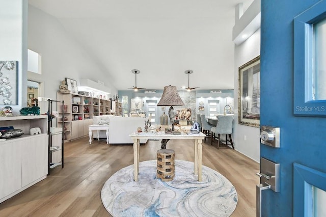 entrance foyer with ceiling fan, high vaulted ceiling, and wood-type flooring