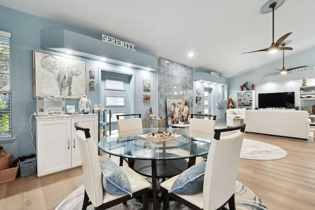 dining area featuring light hardwood / wood-style flooring, ceiling fan, and lofted ceiling