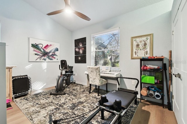 exercise room featuring light hardwood / wood-style floors, ceiling fan, and lofted ceiling